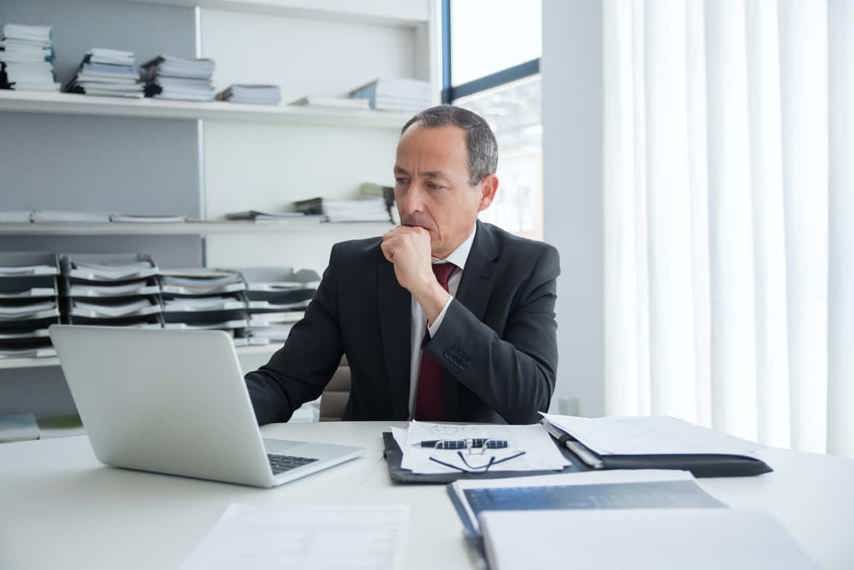 A man at his computer thinking