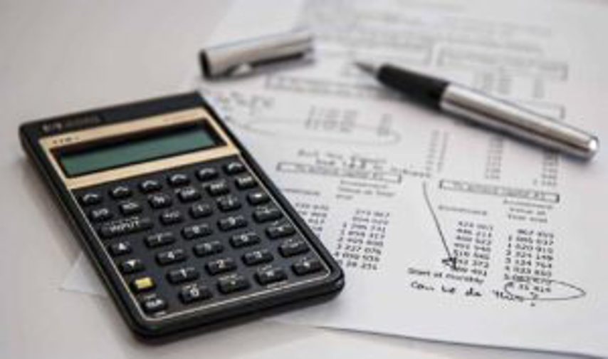 A calculator sits beside a sheet of data