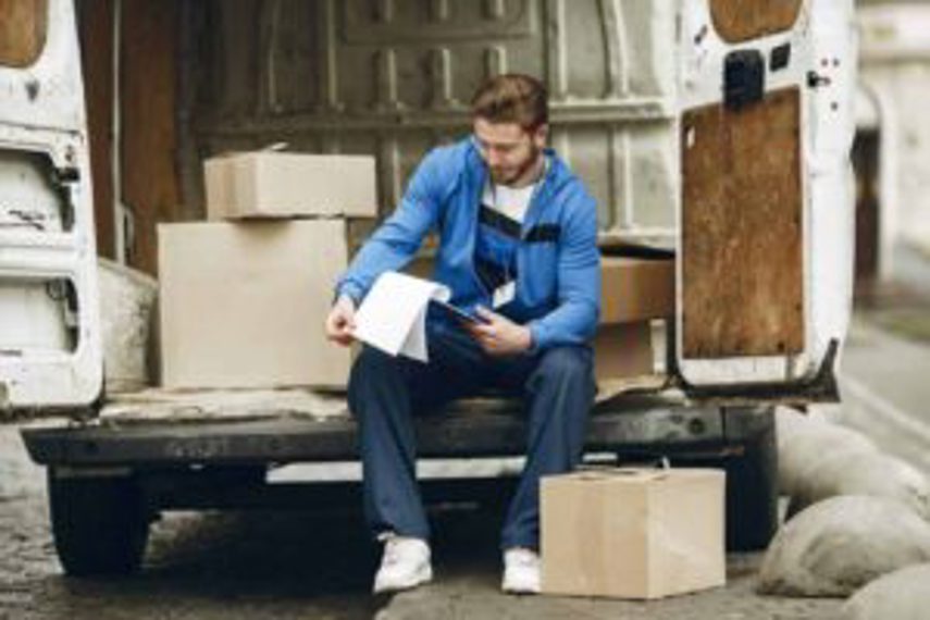 A man checks stock being delivered in boxes