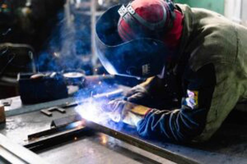 An employee welding as part of the production process