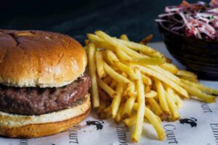 Fries and a burger being served in a restaurant