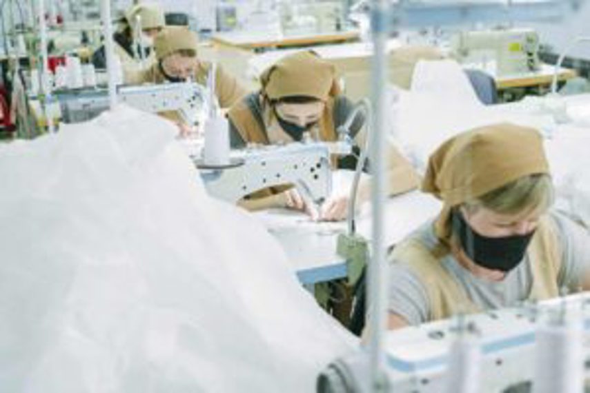 Machinists working on products in factory