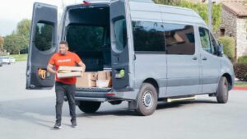 A man delivers products from a van