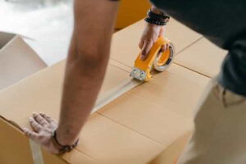 A man packs inventory into a box