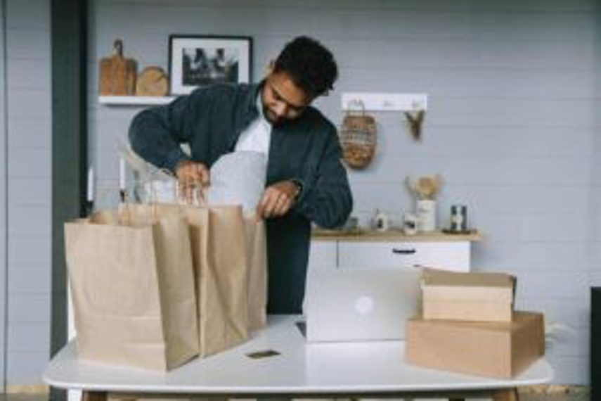 A man takes goods out of a shopping bag