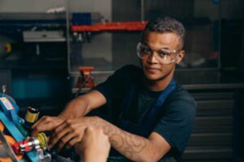 A man works on a product in a factory