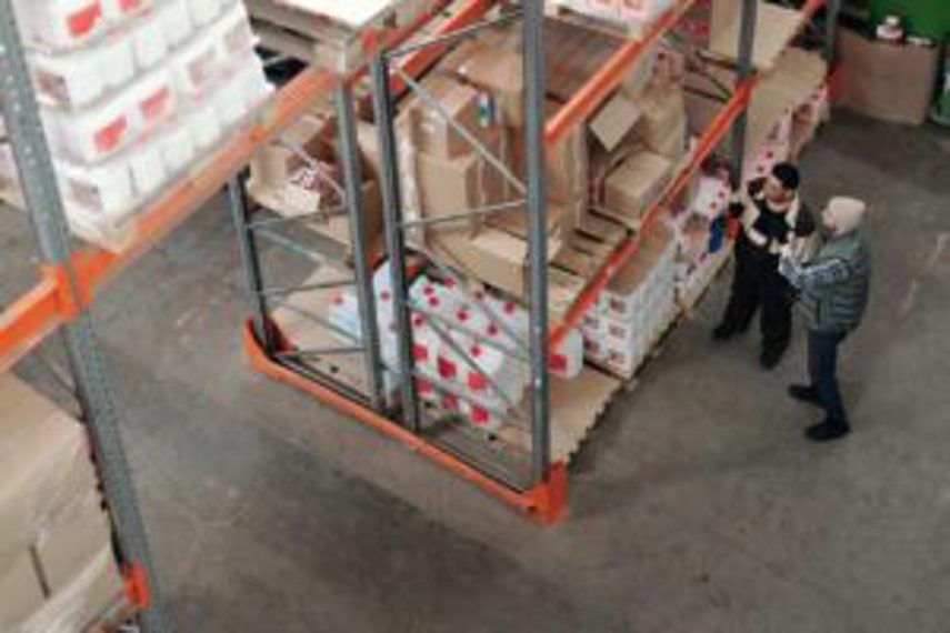 Two men looking at stock in the warehouse