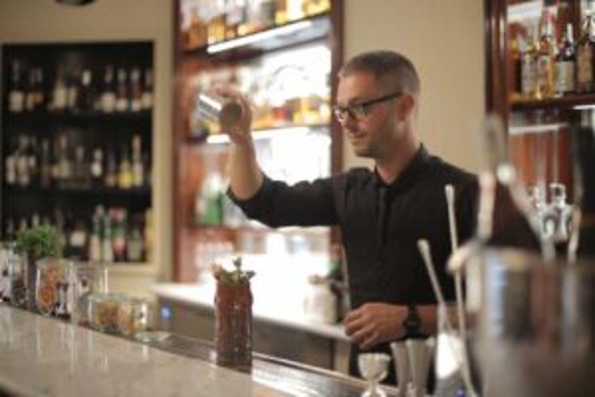 A bartender mixing a cocktail