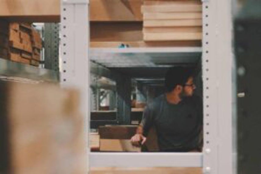 A man looks for raw materials in a warehouse