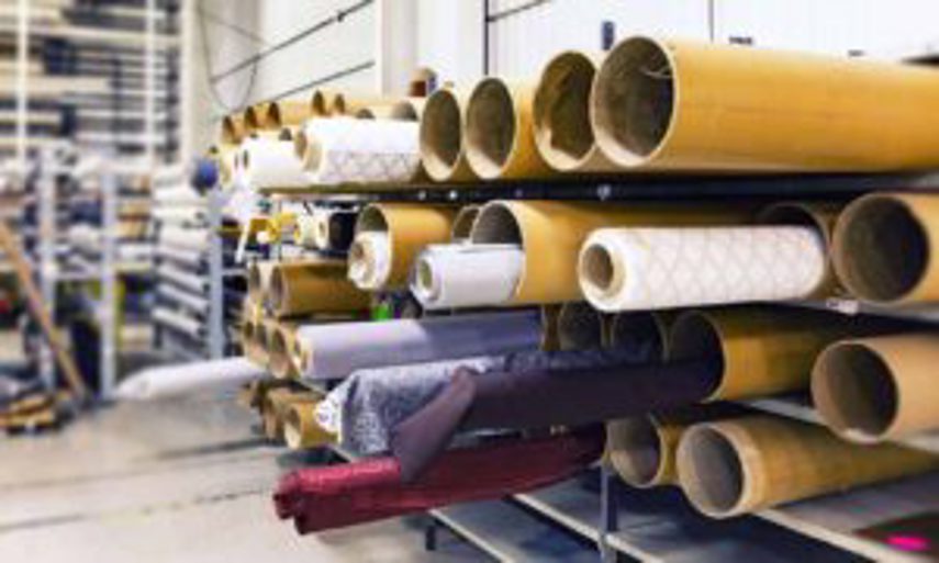 Rolls of materials stacked up in a warehouse