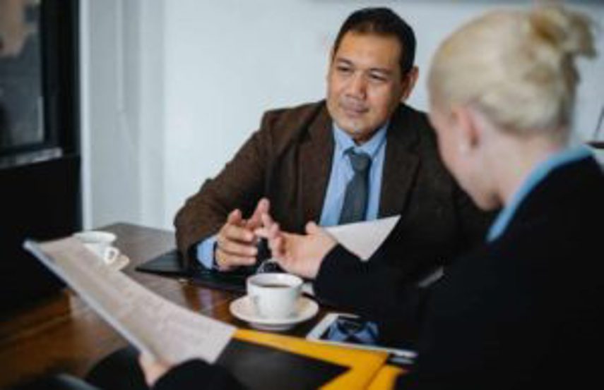 Two managers having a meeting over coffee