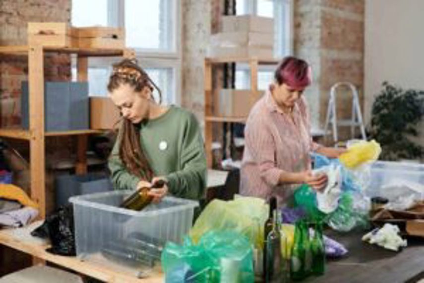 Two women sorting recyclable plastics