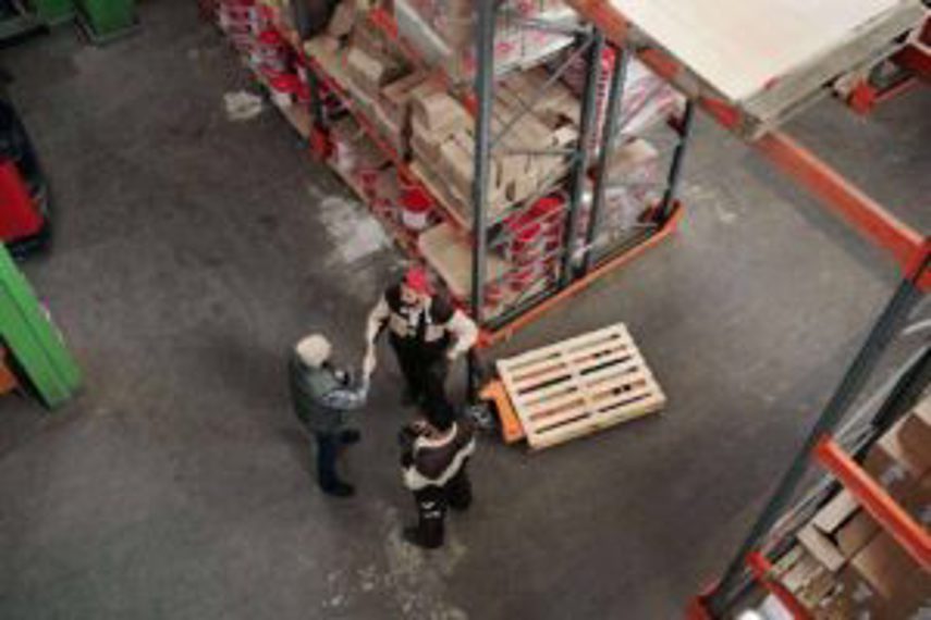 Men shake hands in a warehouse