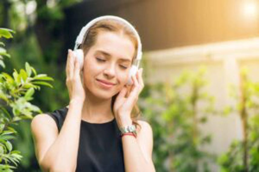 A woman listening to music on headphones