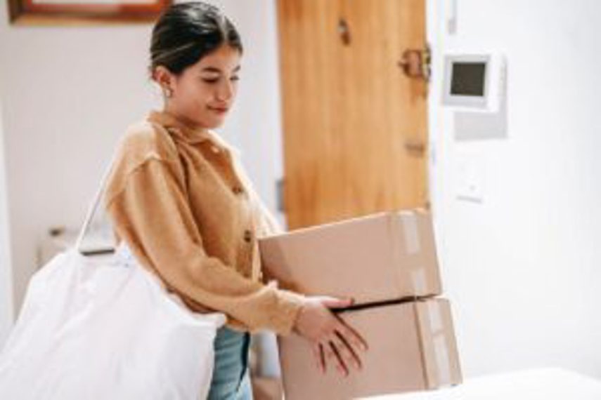  A woman carries boxes of goods