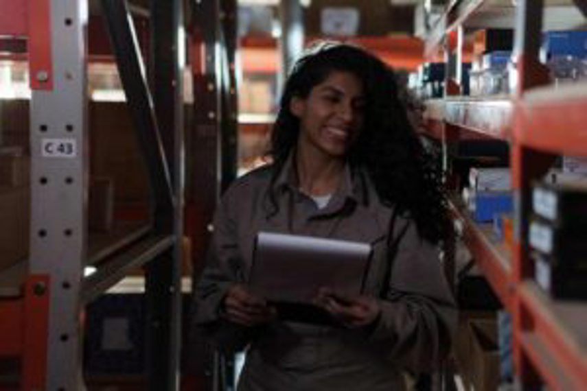 A woman stocktaking in a warehouse