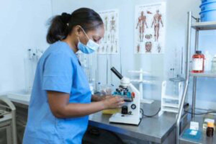 A woman in a hospital lab using equipment