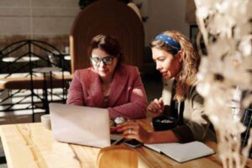 Two women working on their business on a laptop