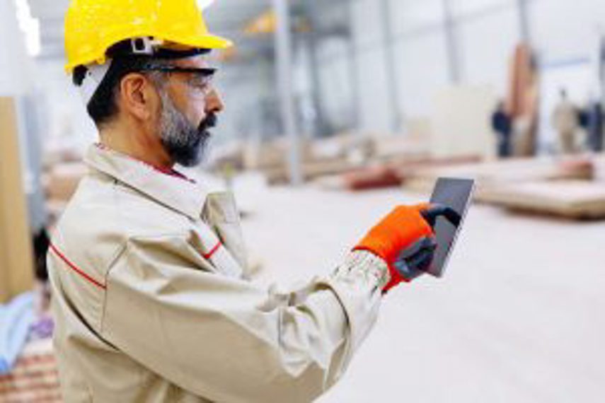 A man manages inventory on his device