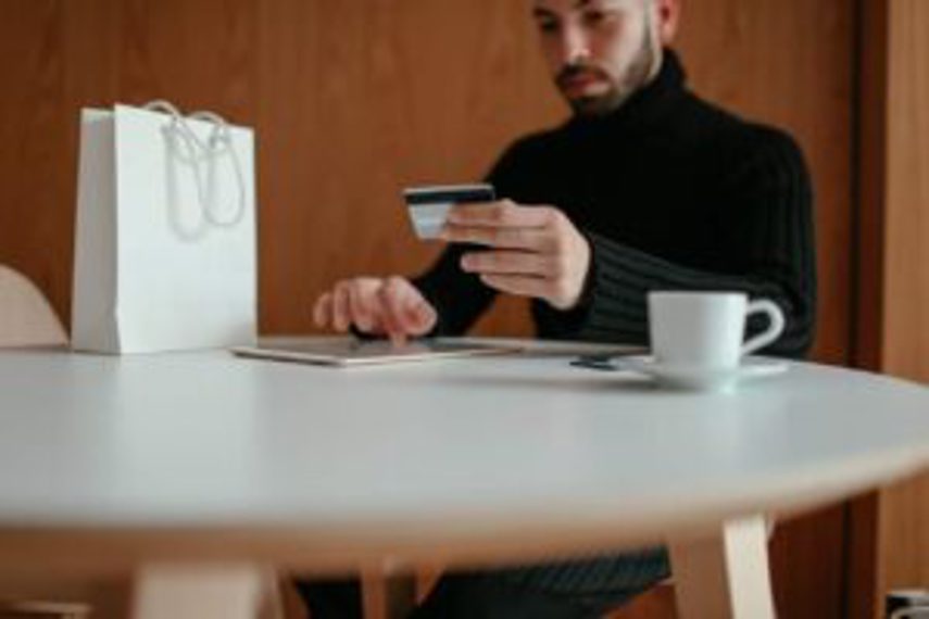 A man using a tablet to do online shopping