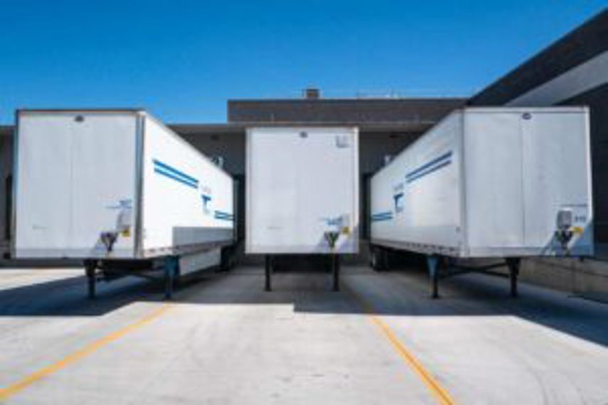 Truck trailers parked outside a warehouse