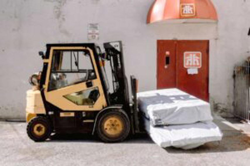 A pallet lifter moving large goods