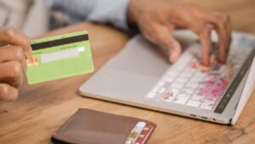 A person shops online with their credit card