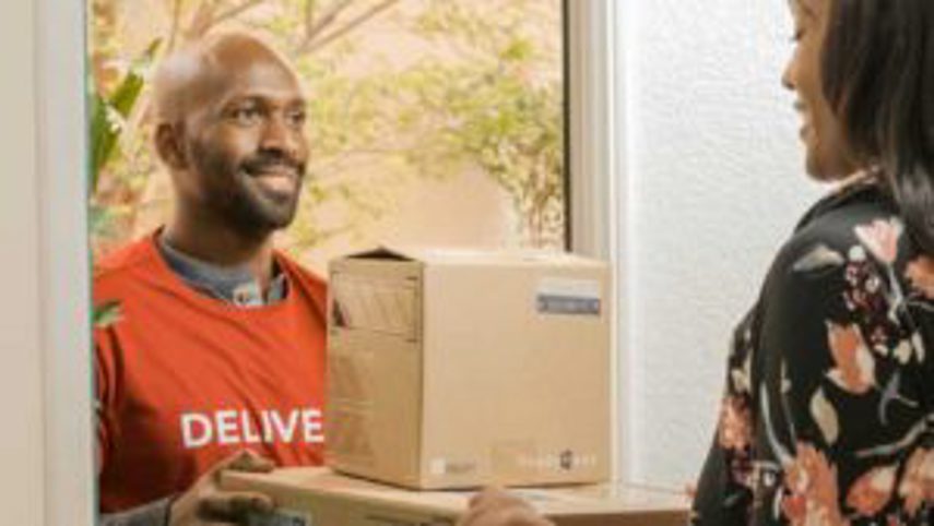 A man delivers packages to a woman's door