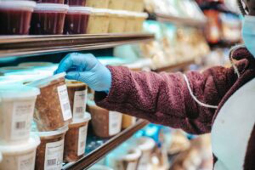 A person looks at packaged food products on a shelf