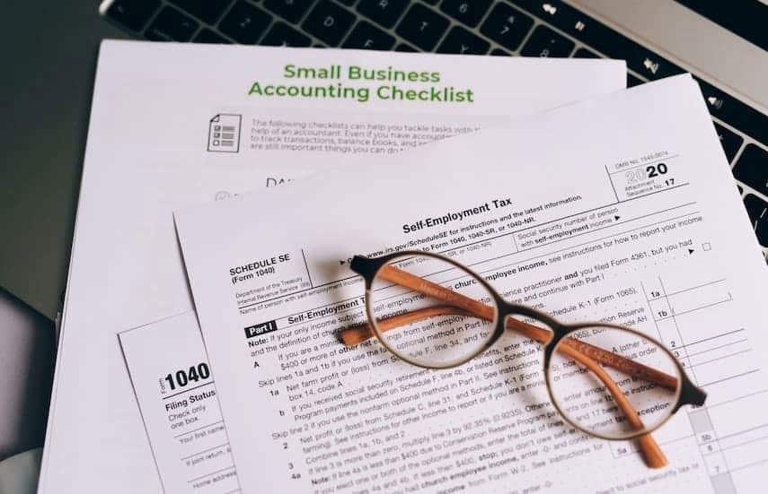 Glasses on top of QuickBooks inventory accounting papers