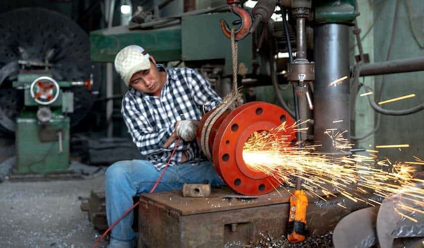 man using the grinding process of manufacturing