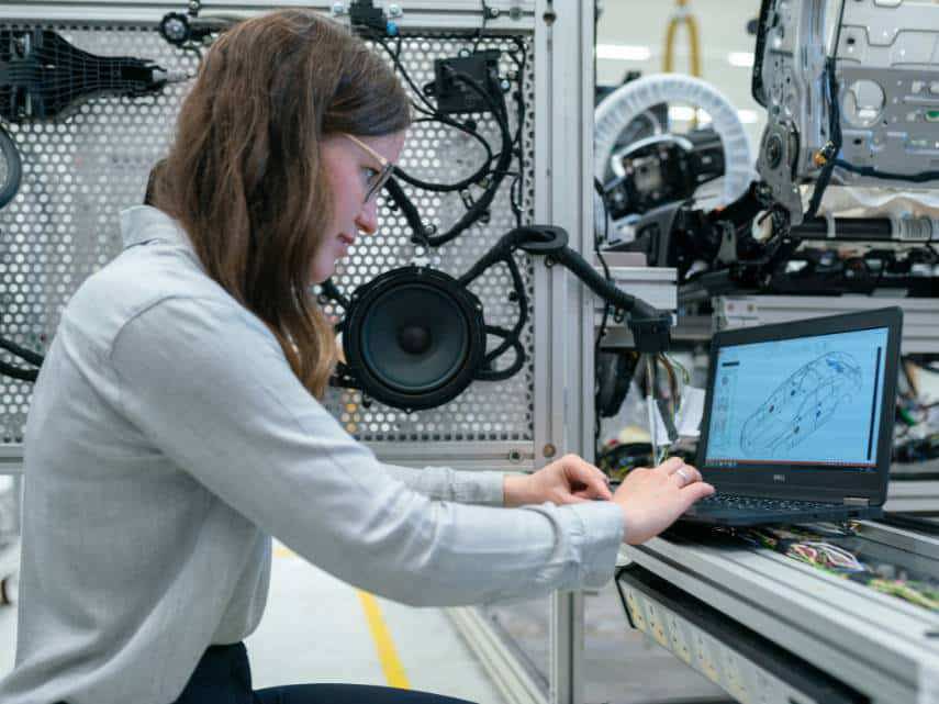 Woman tests a new ERP software system in her warehouse.