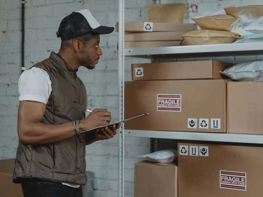 A man picks orders in a warehouse using optimised order picking methods.