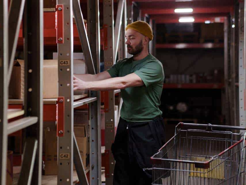 Warehouse worker using the zone order picking method to fulfil an order.